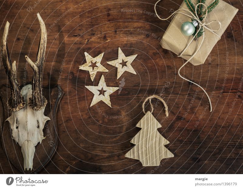 Merry Christmas! A present, three stars a Christmas tree - pendants and antlers hang on a wooden wall Leisure and hobbies Living or residing Decoration Tree