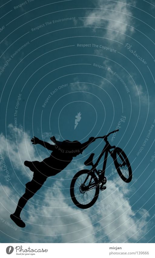 Superman Bicycle Jump Trick Stunt Shows Clouds Man Motorcyclist Mountain bike Reckless Risk Air Stand Dangerous Turquoise Summer Bird Black Progress Practice