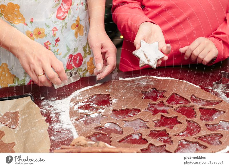 Cutting out the Christmas symbols in the dough for the cookies Table Kitchen Human being Girl Woman Adults Hand 2 8 - 13 years Child Infancy 30 - 45 years Make