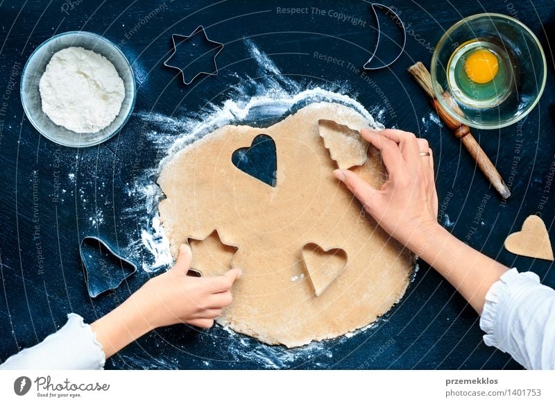 Mom with daughter cutting out the Christmas symbols in the dough Table Kitchen Human being Girl Woman Adults Hand Make Cut Cutter Knife Egg Flour Gingerbread