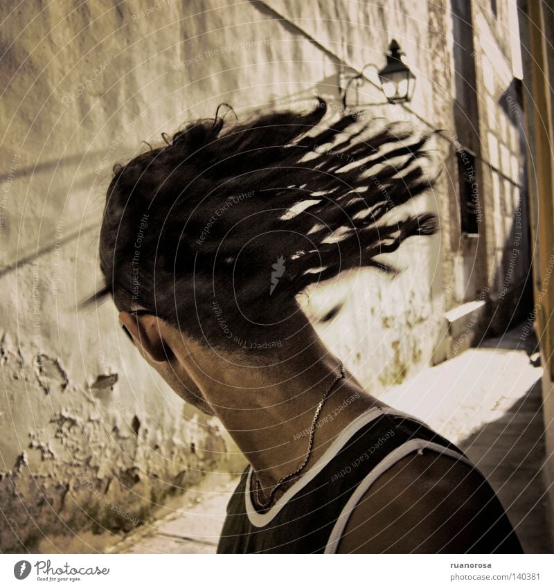 Movement Human being Man Youth (Young adults) Head Dreadlocks Shake of the head Looking back Rotate Swing Spirited Alley Exterior shot Faceless Rear view