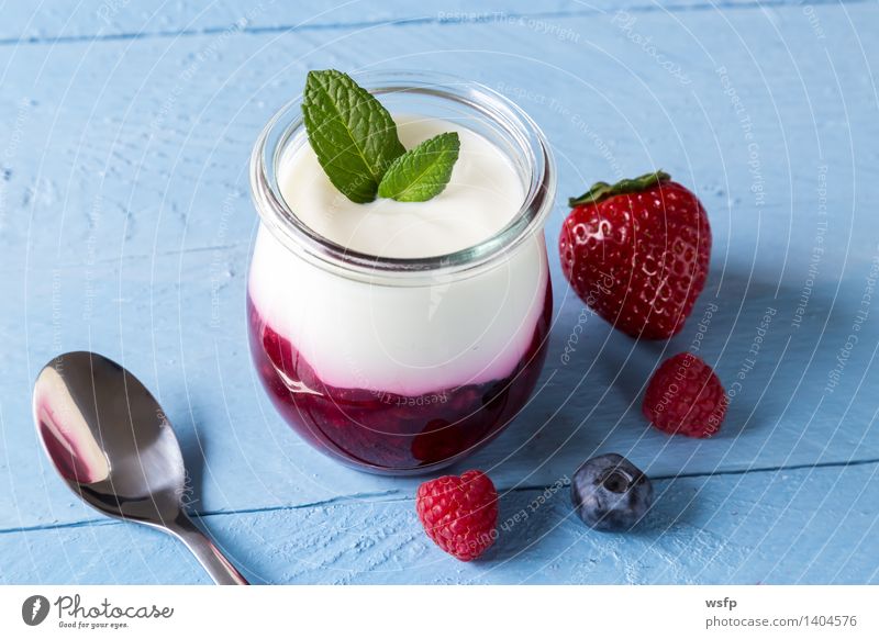 Red fruit jelly with mint Yoghurt Fruit Dessert Wood Blue White red fruit jelly Grits Mint Raspberry Blueberry Blue wood background Strawberry Glass