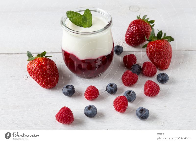 Red fruit jelly with mint Yoghurt Fruit Dessert Wood White red fruit jelly Grits Mint Raspberry Blueberry white wood background Strawberry Glass salubriously
