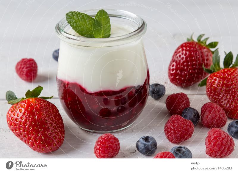 Red fruit jelly with mint Yoghurt Fruit Dessert Wood White red fruit jelly Grits Mint Raspberry Blueberry white wood background Strawberry Glass salubriously