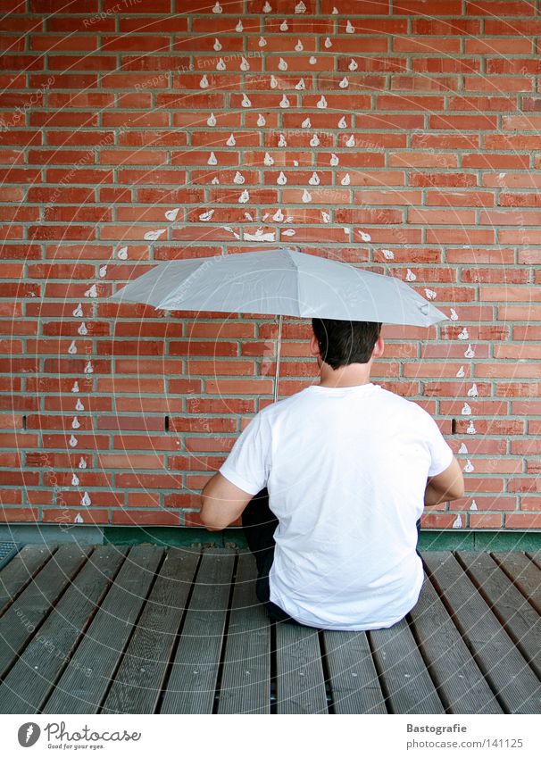 Bad weather, turn your back. Rain Umbrella Wall (building) Brick Man Gale Vacation & Travel Water Autumn Drops of water Weather Freedom Stone
