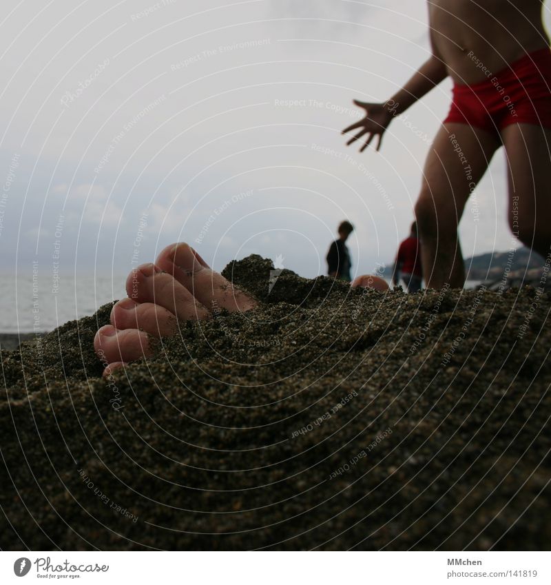 Look, Mama, I found something here.... Beach Child Feet Hand Sand Bury Find Frightening Scare Dangerous Earth buried