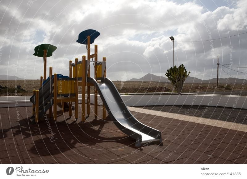 playground Playing Children's game Far-off places Summer Sun Clouds Warmth Playground Loneliness Slide Lanzarote Physics Climbing facility climbing scaffold