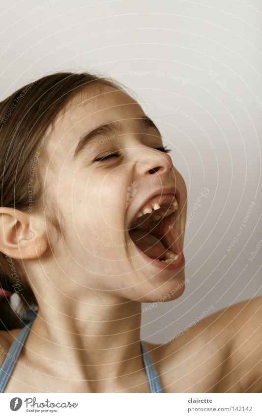 Let it out!! Colour photo Interior shot Neutral Background Portrait photograph Half-profile Closed eyes Joy Child Girl Mouth Laughter Scream Large Applause