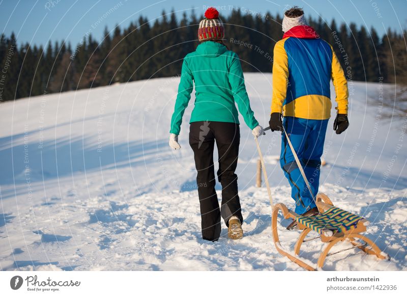 Young couple with sledge Leisure and hobbies Tourism Trip Winter Snow Winter vacation Winter sports Sleigh Human being Masculine Feminine Young woman