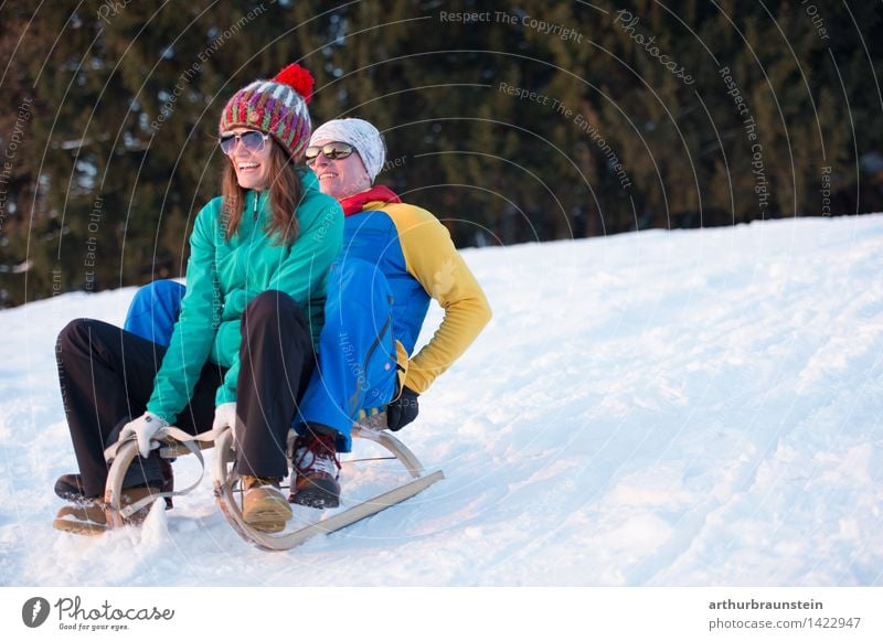 Young couple have fun sledging Joy Leisure and hobbies Winter Snow Winter vacation Winter sports Sleigh Ski run Human being Masculine Feminine Young woman