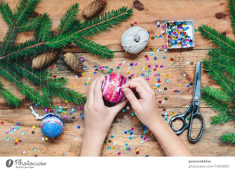 Girl making Christmas ball pinning the sequins onto the ball Handcrafts Decoration Table Scissors 1 Human being Wood Ornament Creativity christmas colorful