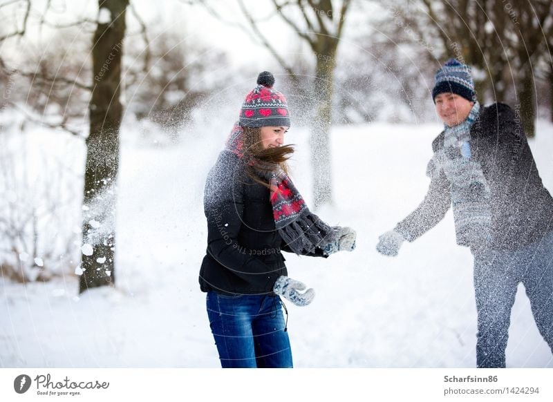 Loving couple throws snow in winter park. Leisure and hobbies Valentine's Day Ski run Masculine Feminine Youth (Young adults) Body 2 Human being 18 - 30 years