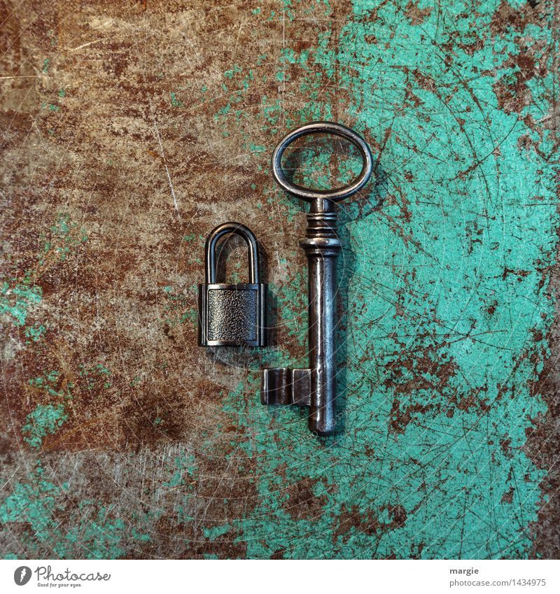 An unequal pair in Q-format: small lock with large key on rusty metal Work and employment Profession Craftsperson Workplace Construction site Tool Technology