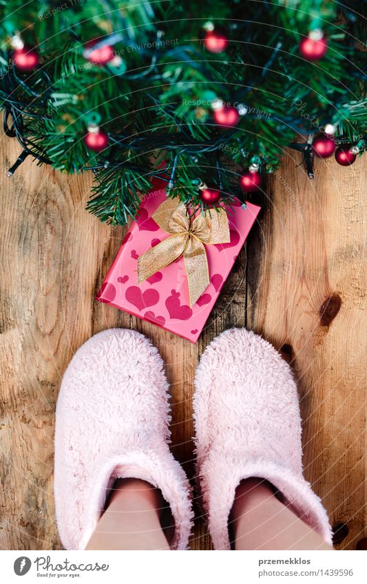 Child looking down at present under Christmas tree Decoration Christmas & Advent Human being Feet Tree Wood Tradition Guest christmas December Story Gift