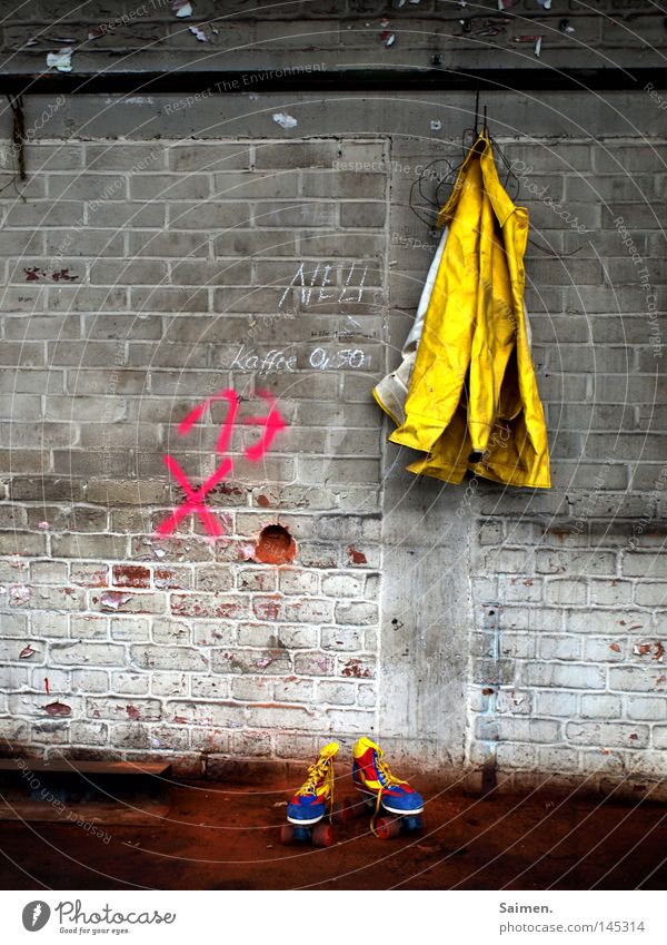 joy and sorrow Raincoat Roller skates Dirty Stone Warehouse Hall Shabby Contrast Converse Cold Wet Multicoloured Yellow Red Blue Wall (building) Ground Hang up