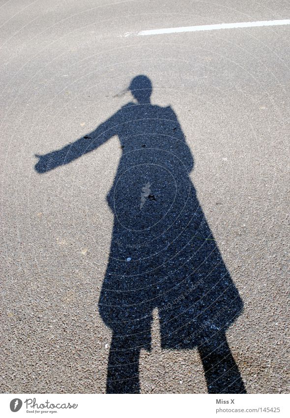 the hitchhiker Colour photo Exterior shot Shadow Silhouette Woman Adults Hand Beautiful weather Street Lanes & trails Stone Driving Gray Black Shadow play