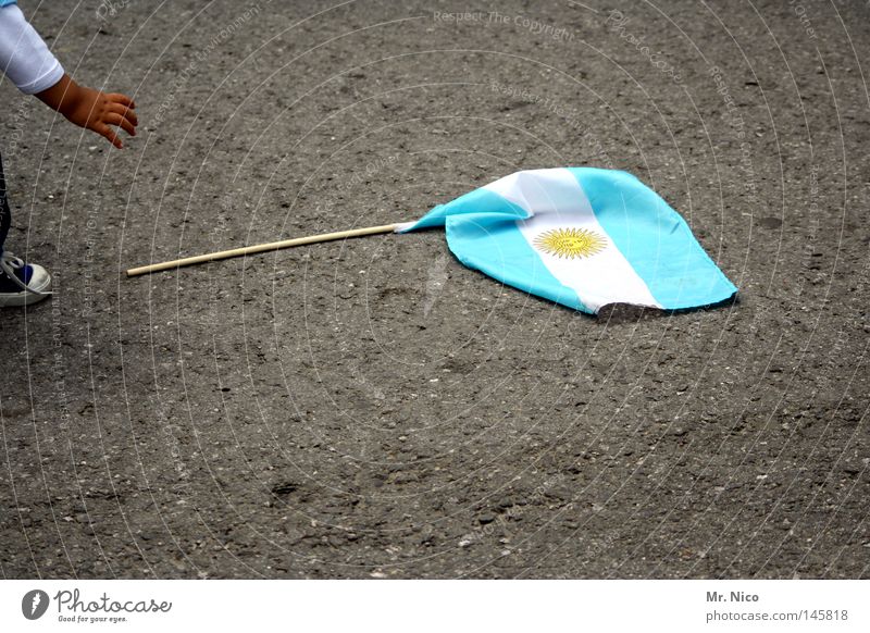 Viva Argentina ! Flag Ensign South America Stick Light blue White Gray Yellow Stripe Cloth Asphalt Child Hand Fingers Grasp Fan Symbols and metaphors Pride Lift