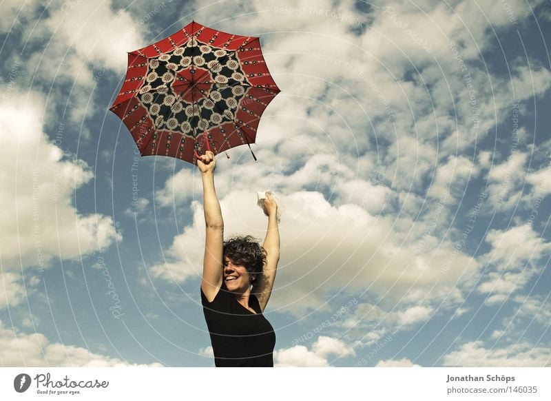 young woman with red umbrella stretches her arms in the blue sky for joy Joy luck Hair and hairstyles Contentment Far-off places Success Youth (Young adults)