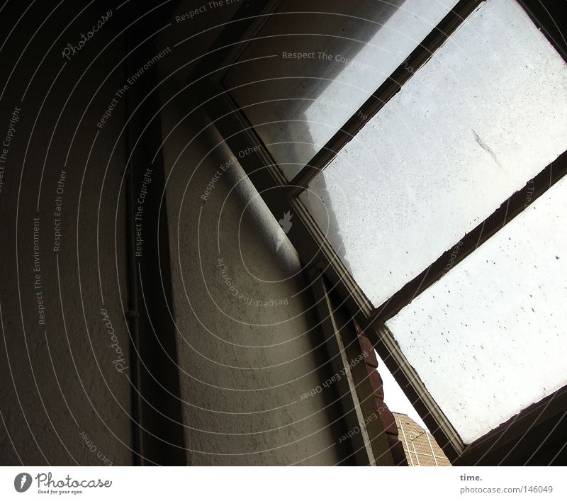 HH08.3 - Warehouse. Fourth floor. Stair landing. Window Above Prop Window frame Derelict tilt window Upward cross strut Subdued colour Interior shot Detail Day