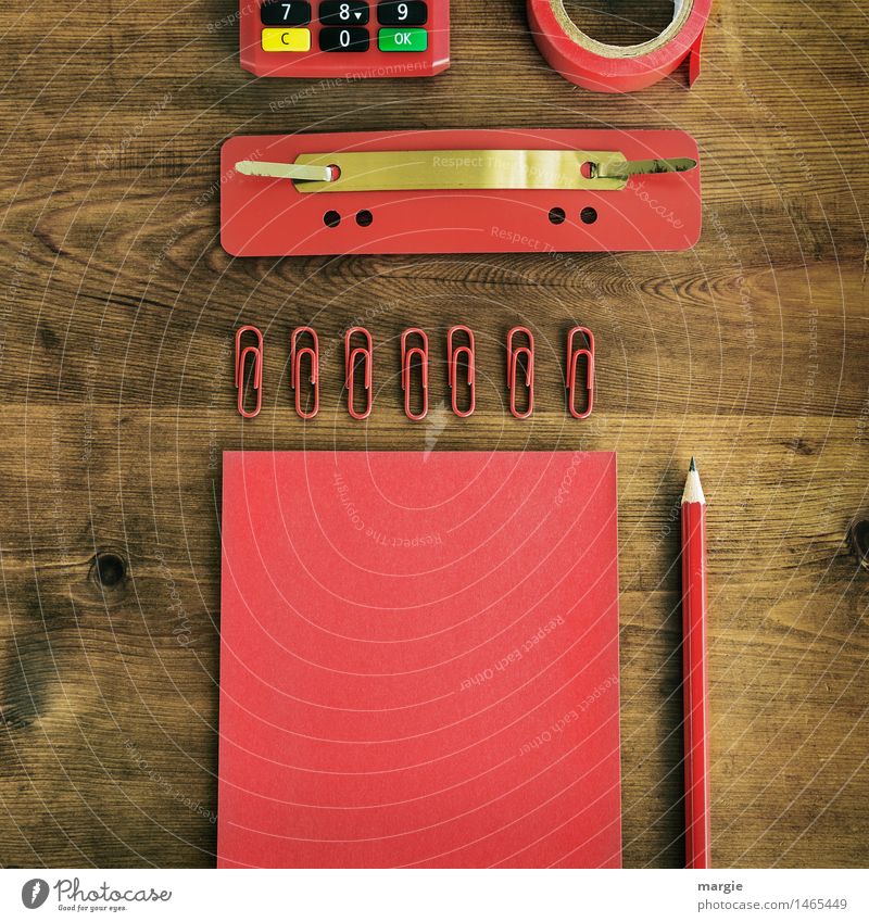 In Q-format: red writing utensils, paper, notepaper, pencil, paper clips, staple, adhesive tape, calculator on a wooden desk Desk Professional training Study