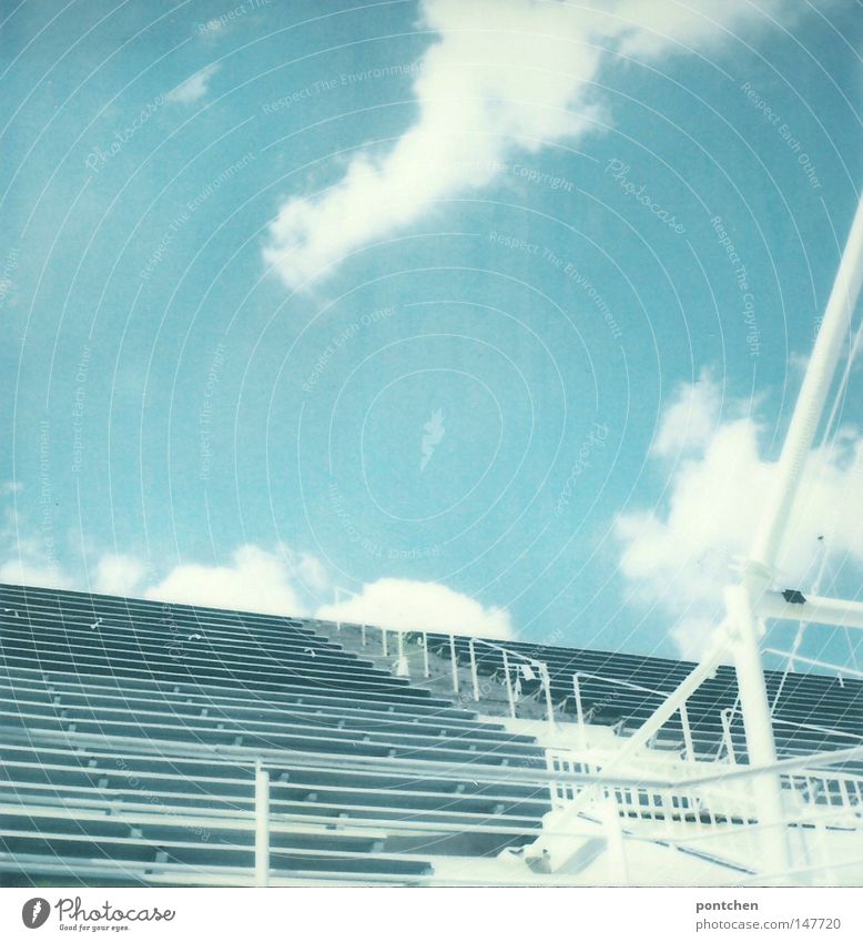 Empty seating area of a sports stadium against a blue sky Colour photo Polaroid Copy Space left Copy Space right Copy Space top Copy Space middle Day Sunlight