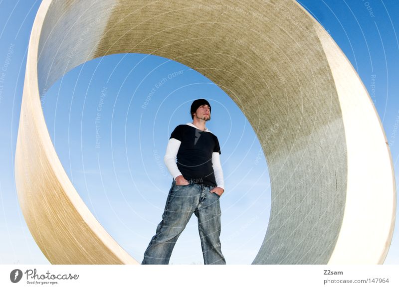 center Stand Human being Man Cap Style Round Concrete Construction site Sky Easygoing Wide angle Motionless Material Think Center point Jeans Blue Cool (slang)