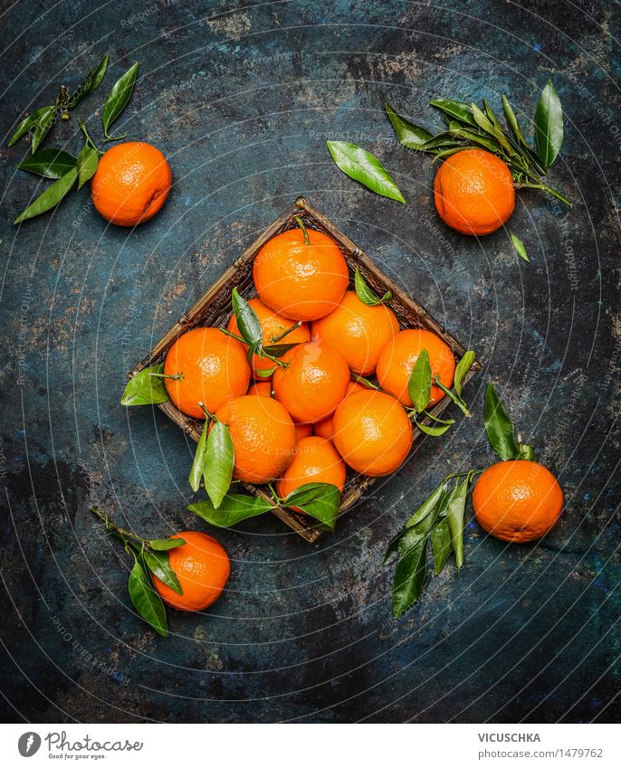Premium Photo  Mandarins scattered across the table from a blue pouch. fresh  mandarin oranges fruit or tangerines on gray table. flat lay and copy space
