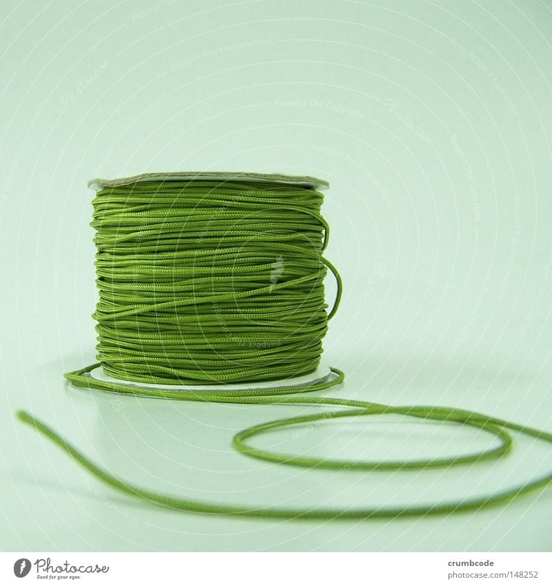 off the roll Craft (trade) Green Wound up Coil Product photography Things Sewing thread Close-up Still Life Deserted Studio shot Handcrafts String