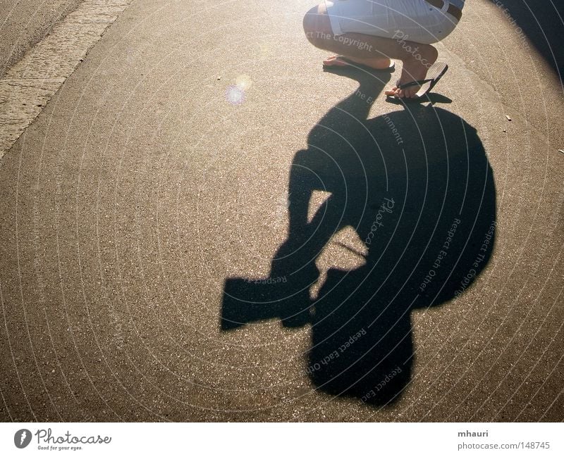 shadow Photographer Shadow Sun Light Silhouette Conceptual design Sandal Man Camera Objective Legs Kneel Tunnel Leisure and hobbies Street