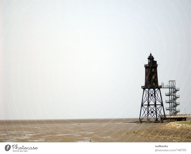Lighthouse at low tide Architecture Low tide Mud flats Beach Water Ocean North Sea Germany Europe Beacon Lamp Coast Building Steel processing Lighting Conduct