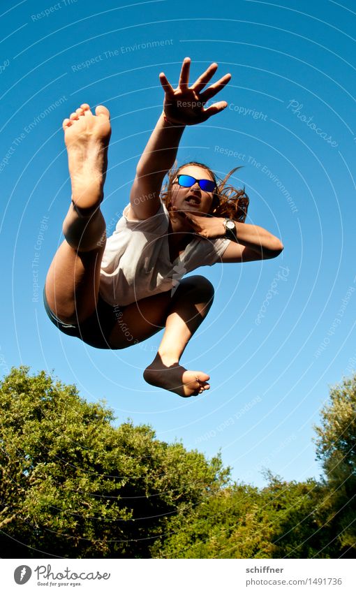 Young woman makes kung fu figure while jumping on trampoline Leisure and hobbies Playing Human being Feminine Girl Youth (Young adults) Hand Fingers Feet 1