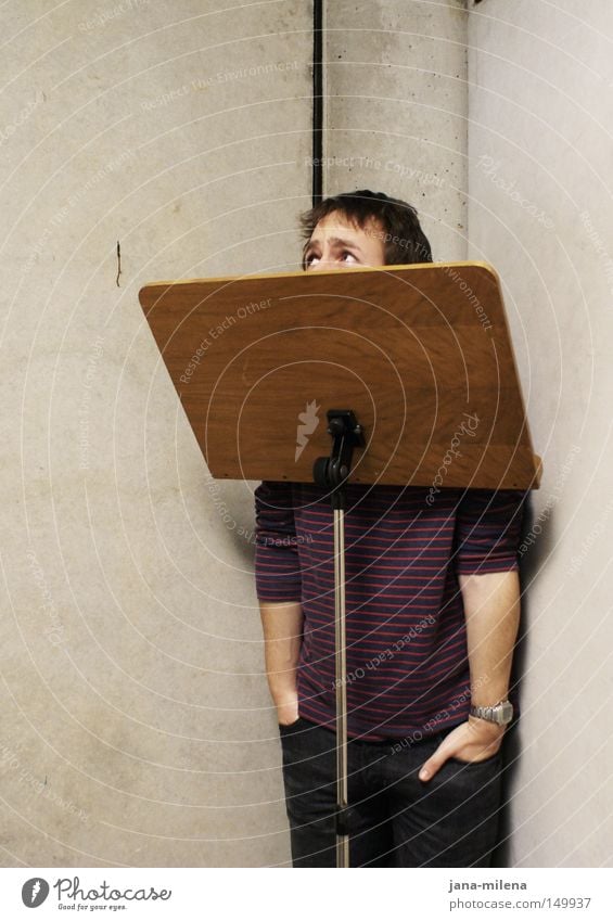 Can I come out?? Concrete Music Practice Stand Corner Timidity Guilty Ask Hand Sweater Looking Concealed Hide Fear Panic Man Obscure cubicle music stand