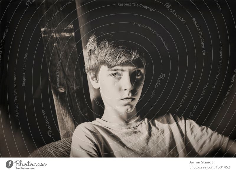 Portrait of a teenager in black and white Lifestyle Style Design pretty Senses Relaxation Calm Armchair Attic Human being Masculine Young man