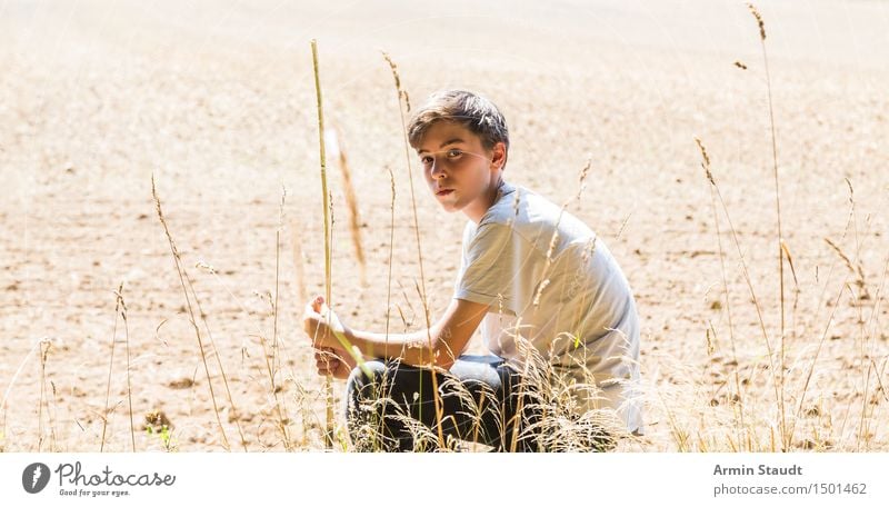 lonely, pensive teenager sits in a field Lifestyle Beautiful Senses Relaxation Calm Human being Masculine Young man Youth (Young adults) 1 13 - 18 years
