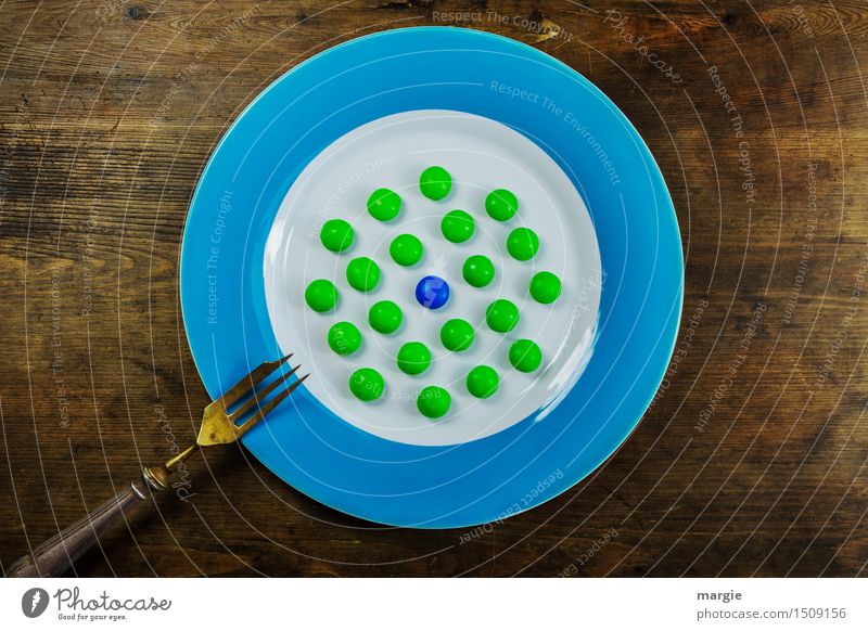 To the point! A plate with a blue rim, on it many green and a blue ball, dots and a fork on a wooden table Dessert Candy Nutrition Picnic Organic produce