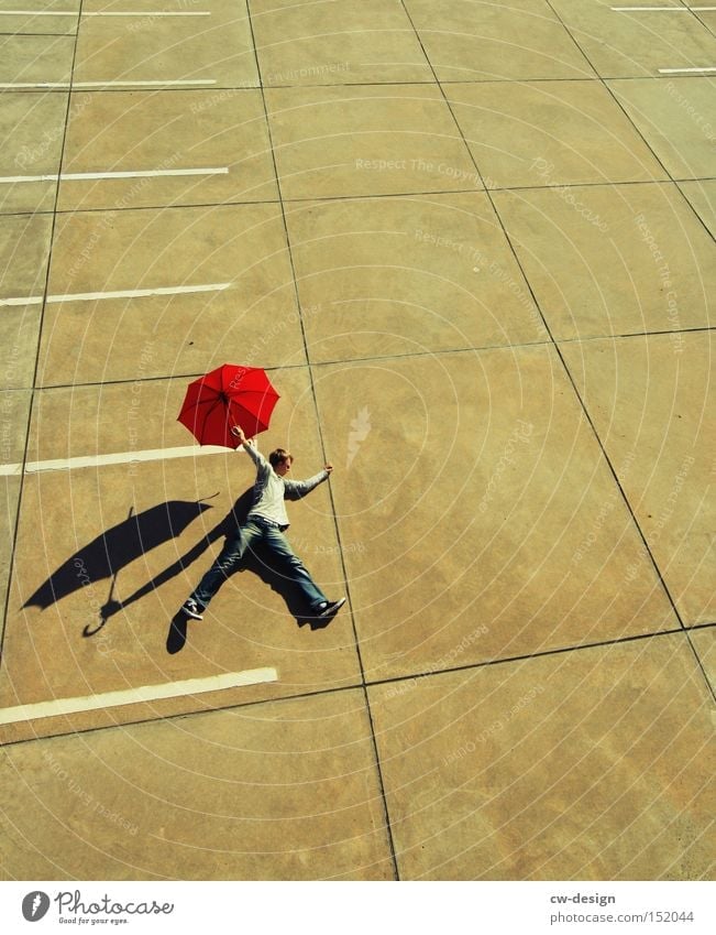 A PHOTO OFF THE PEG Umbrella Human being Red Concrete Bird's-eye view Parking lot Parking level Beautiful weather Shadow Man Masculine Stand Lie Sunshade