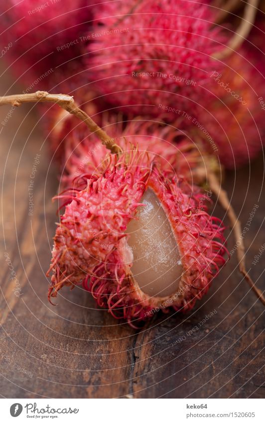 fresh tropical rambutan fruits over rustic wood table Fruit Dessert Nutrition Exotic Group Nature Plant Fresh Delicious Natural Juicy Red White Rambutan food