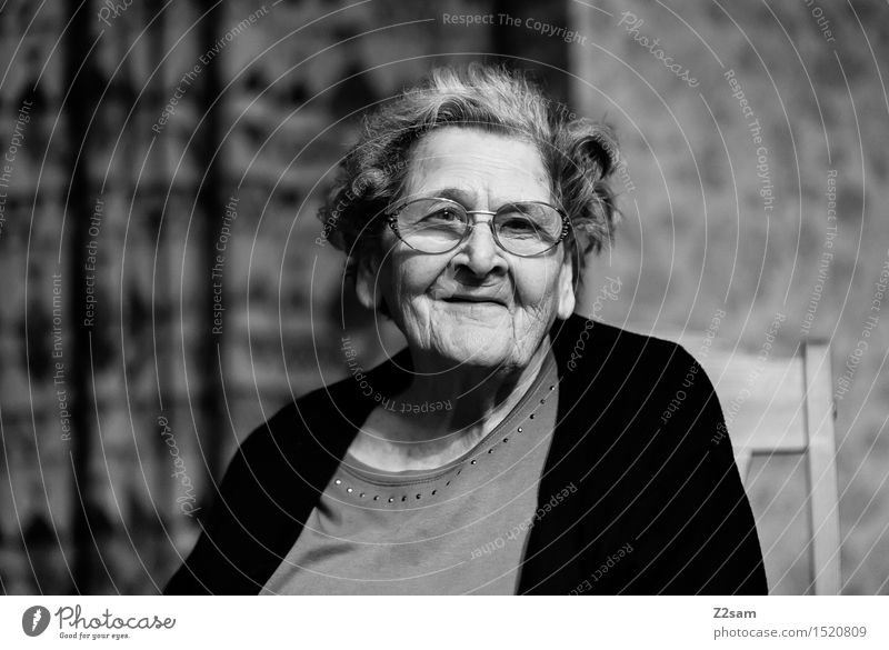 Photo by Linda M, - Black and white portrait of a smiling elderly woman  with gray hair in a floral dress