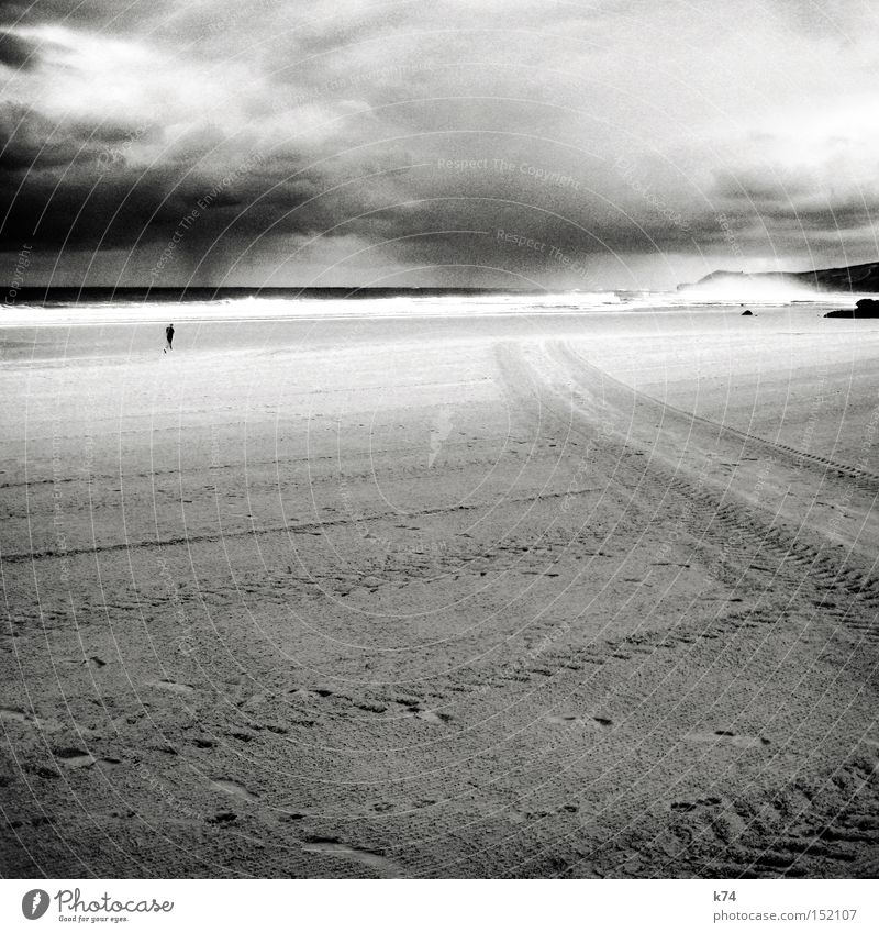 rain Sky Weather Clouds Tracks Coast Beach Ocean Human being Jogger Rain Gale Skid marks Surf Black & white photo