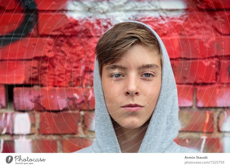 Portrait of a teenager with hoodie, in front of a red brick wall Lifestyle Style Design pretty Harmonious Well-being Contentment Human being Masculine Young man