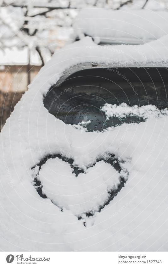 Snow heart shape on car. Winter Car Heart Love Happiness White Romance ice cold Symbols and metaphors Frost romantic window drawing background glass Frozen