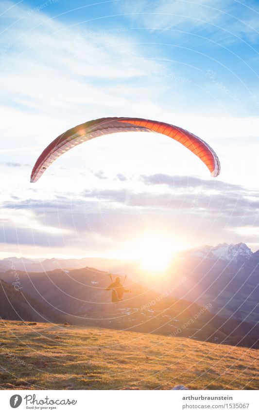 Paraglider at sunrise Lifestyle Joy Athletic Leisure and hobbies Parachute Trip Freedom Mountain Sports Paragliding Human being Masculine Feminine Young woman