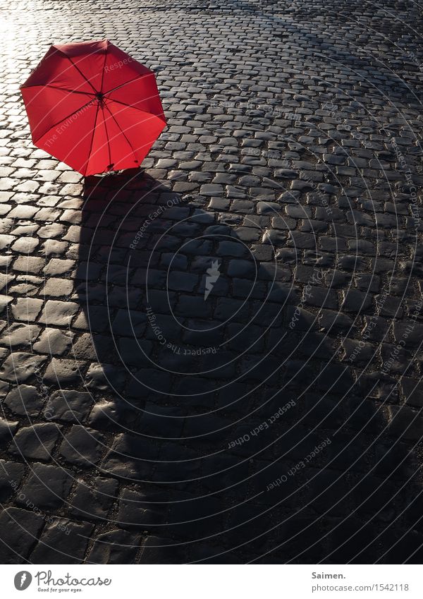 urban colour play Town Traffic infrastructure Street Moody Umbrella Cobblestones Red Colour photo Exterior shot Deserted Copy Space bottom Copy Space middle