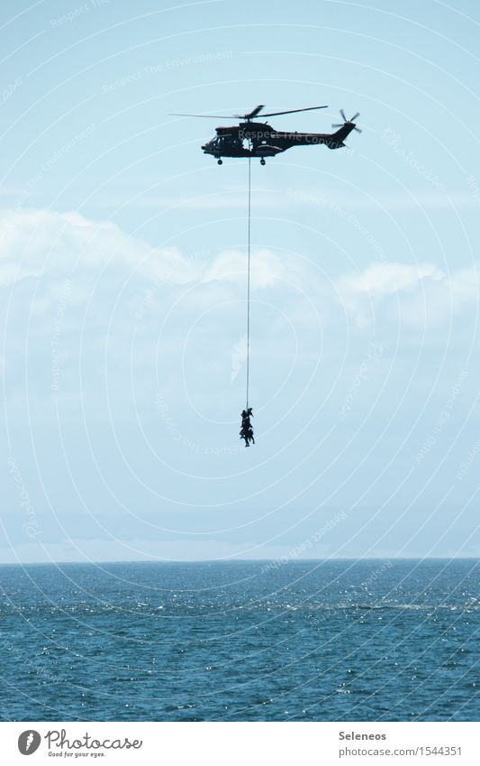 hang out Human being Sky Clouds Horizon Ocean Aviation Helicopter Maritime Rescue Colour photo Exterior shot Copy Space bottom