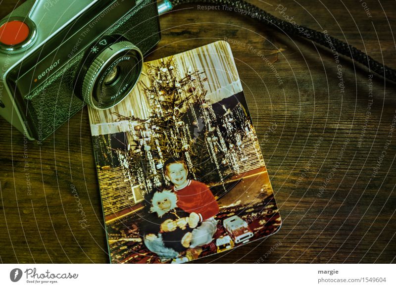 Nostalgia - Christmas Joy- An old analogue camera with a photo of a little boy sitting in front of a Christmas tree Feasts & Celebrations Christmas & Advent