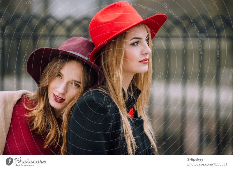 Two girls sitting on the bench and smile Lifestyle Joy Happy Beautiful Face Meeting Human being Feminine Woman Adults Friendship Autumn Fashion Hat Listening