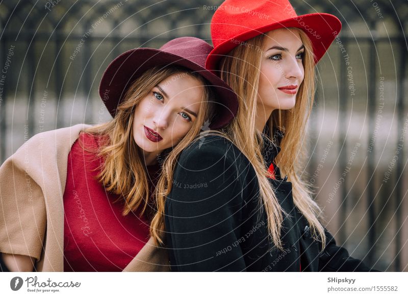 Two girls sitting on the bench and smile Lifestyle Joy Happy Beautiful Face Meeting To talk Human being Feminine Woman Adults Friendship Autumn Fashion Hat