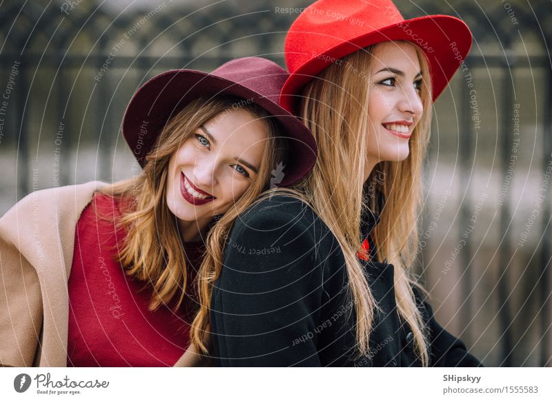 Two girls sitting on the bench and smile Lifestyle Joy Happy Beautiful Face Meeting To talk Human being Feminine Woman Adults Friendship Teeth Autumn Fashion