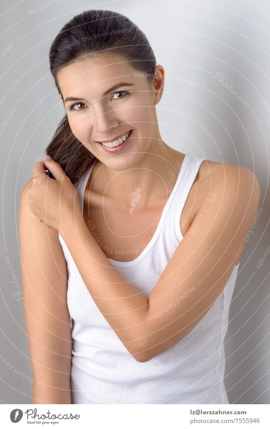 Single cute woman holding ponytail Happy Beautiful Skin Face Contentment Feminine Woman Adults 1 Human being 30 - 45 years Brunette Hair Old Smiling Laughter
