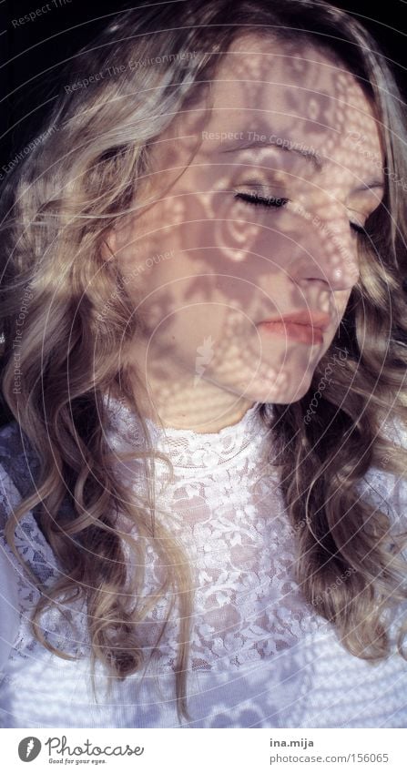 young blonde woman with curly hair has her eyes closed and shadows on her face pretty Hair and hairstyles Skin Face Cosmetics Make-up Contentment Relaxation